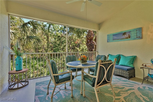 sunroom / solarium with ceiling fan and vaulted ceiling