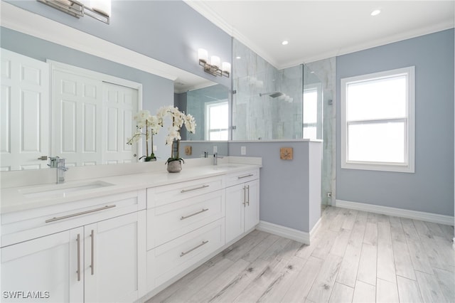 bathroom featuring wood-type flooring, crown molding, walk in shower, and vanity