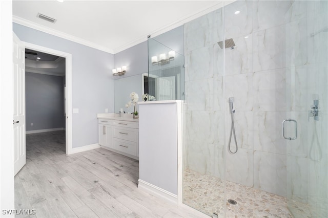 bathroom featuring hardwood / wood-style floors, an enclosed shower, ornamental molding, and vanity