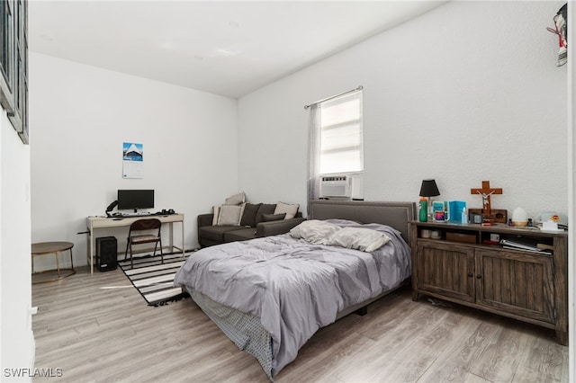 bedroom featuring cooling unit and light wood-type flooring