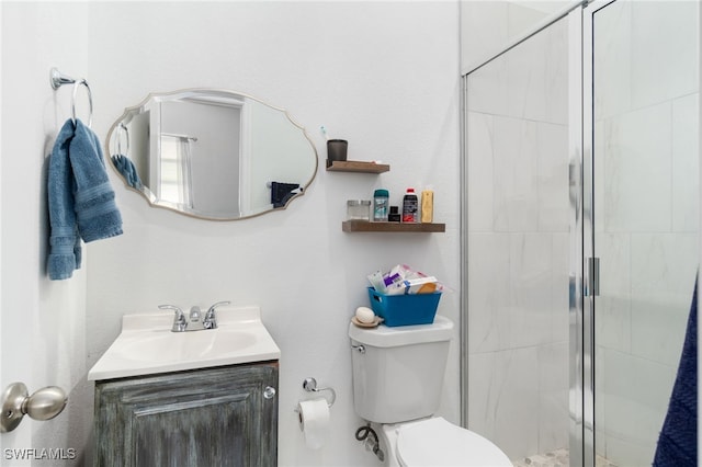 bathroom with toilet, a shower with door, and vanity