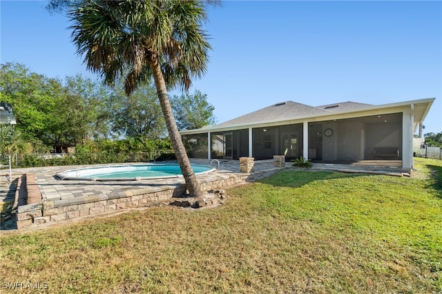 rear view of house with a sunroom and a lawn