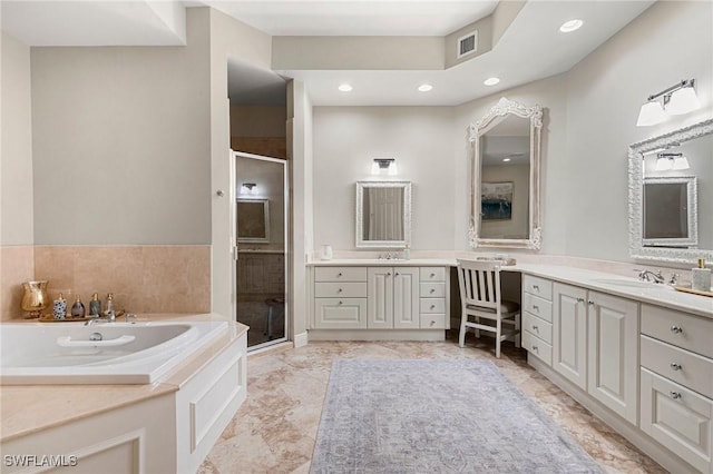 bathroom featuring vanity and separate shower and tub