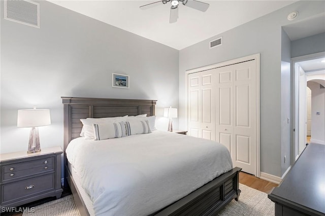 bedroom featuring light hardwood / wood-style flooring, a closet, and ceiling fan