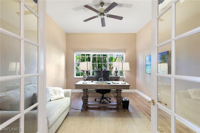 home office with ceiling fan, french doors, and wood-type flooring