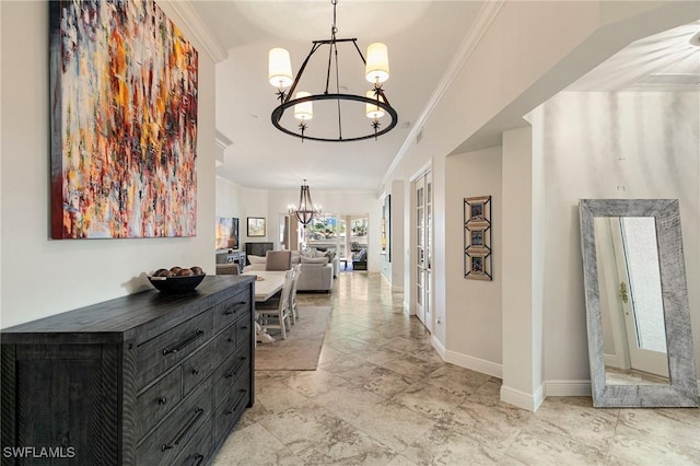 corridor featuring an inviting chandelier and crown molding