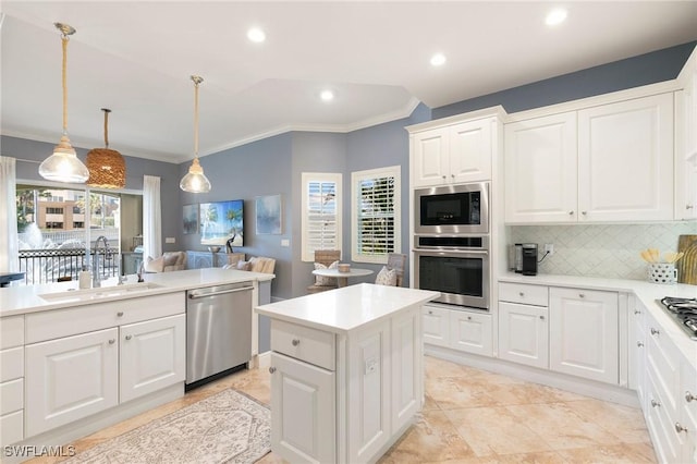 kitchen with white cabinets, appliances with stainless steel finishes, pendant lighting, and sink