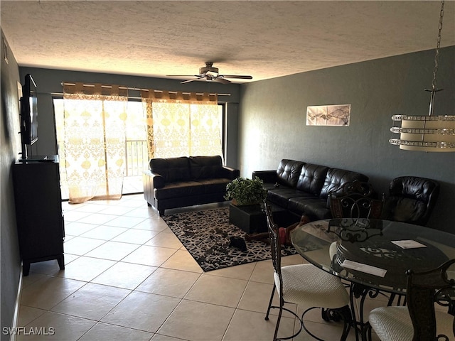 tiled living room featuring ceiling fan and a textured ceiling