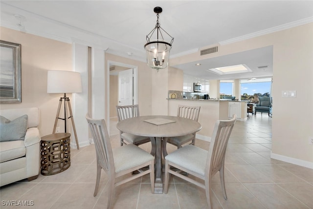 tiled dining area with ornamental molding and a chandelier