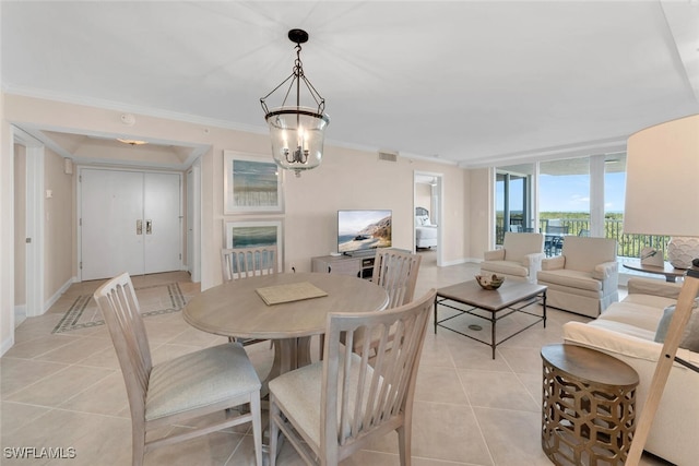 tiled dining space with an inviting chandelier and crown molding