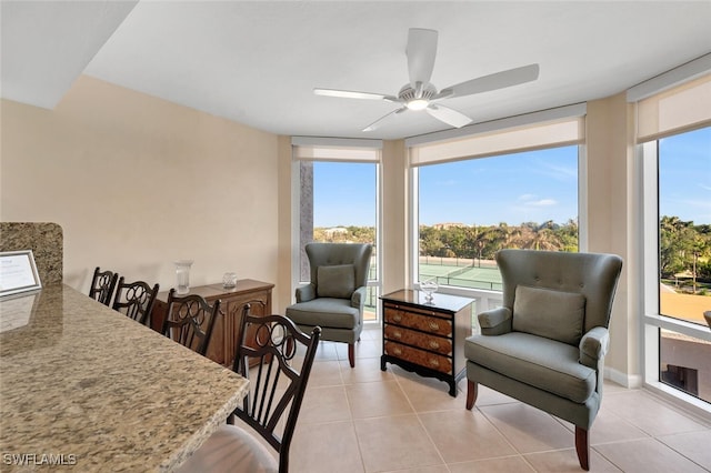 interior space with ceiling fan, light tile patterned floors, and a wealth of natural light