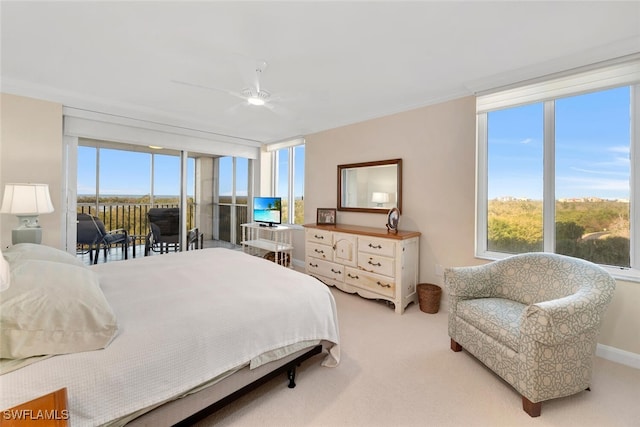 bedroom featuring multiple windows, ceiling fan, and light colored carpet