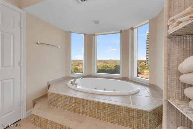 bathroom featuring tile patterned flooring and tiled bath