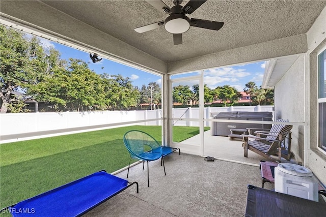 sunroom featuring ceiling fan