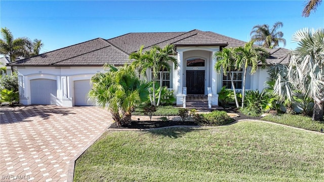 view of front of house with a garage and a front lawn