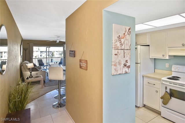 kitchen with light tile patterned floors, white appliances, ventilation hood, and ceiling fan