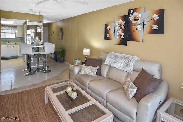 tiled living room featuring ceiling fan and sink