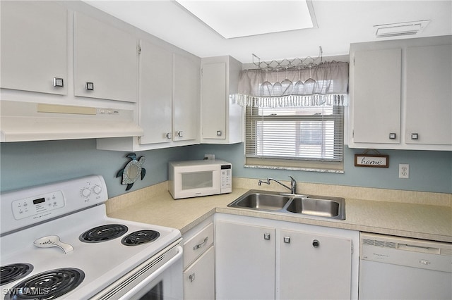 kitchen featuring white appliances, white cabinetry, and sink