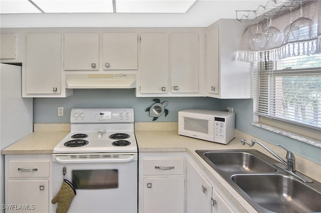 kitchen with ventilation hood, white cabinetry, white appliances, and sink