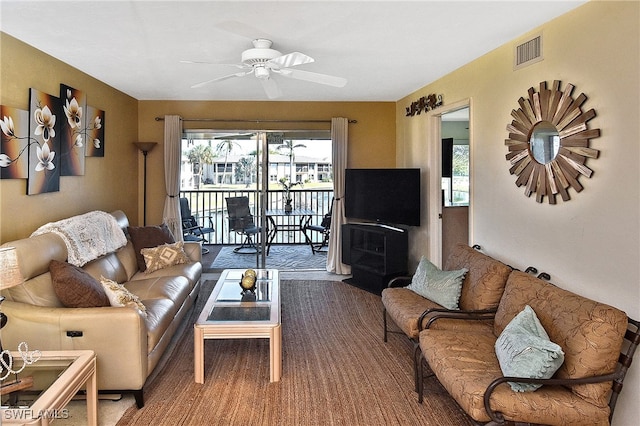 living room featuring carpet floors, a wealth of natural light, and ceiling fan