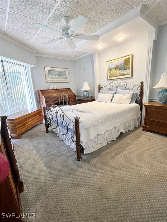 carpeted bedroom featuring a textured ceiling, ceiling fan, and crown molding