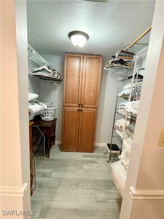 spacious closet featuring light hardwood / wood-style floors