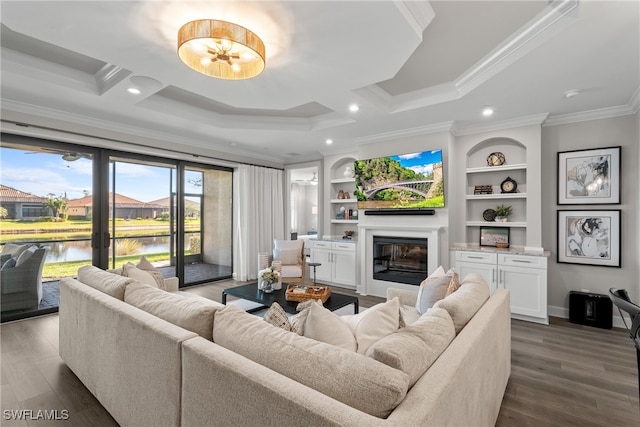 living room with built in features, crown molding, and dark wood-type flooring