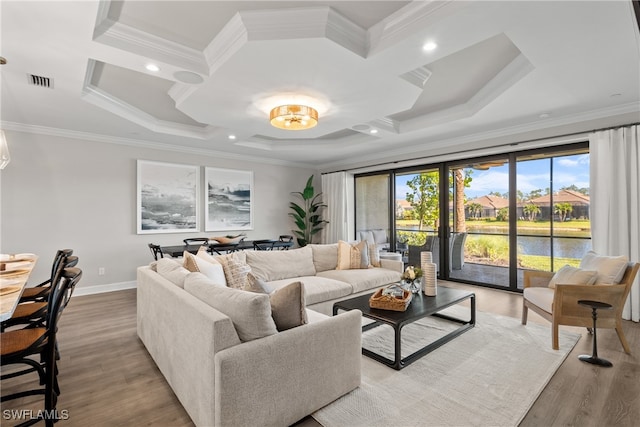 living room with a water view, light wood-type flooring, and crown molding