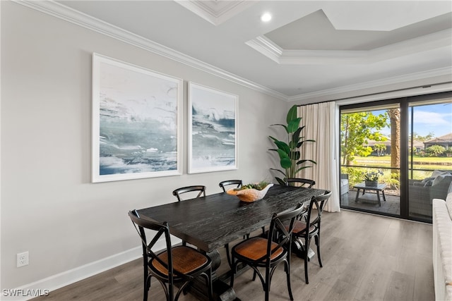 dining space featuring crown molding and hardwood / wood-style floors