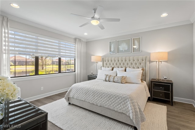 bedroom featuring dark hardwood / wood-style floors, ceiling fan, and ornamental molding