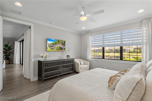 bedroom with dark hardwood / wood-style flooring, ceiling fan, and ornamental molding