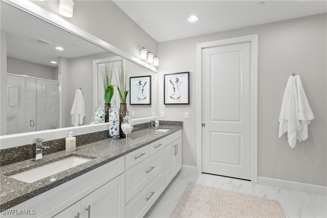 bathroom with vanity and a shower with shower door