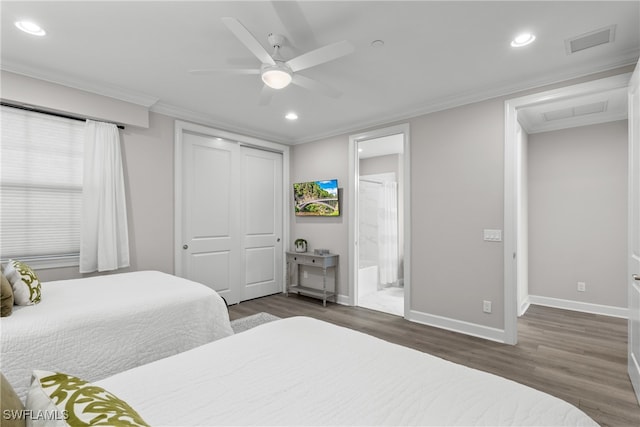 bedroom featuring ornamental molding, ceiling fan, connected bathroom, dark hardwood / wood-style floors, and a closet