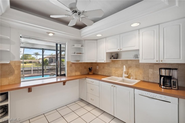 kitchen featuring dishwasher, white cabinets, sink, ceiling fan, and light tile patterned flooring