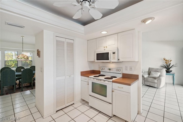 kitchen with light tile patterned floors, white appliances, white cabinetry, and pendant lighting