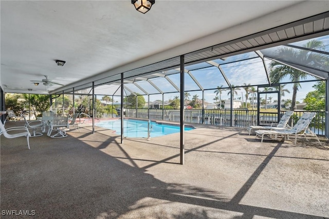 view of swimming pool featuring a lanai, a patio area, and ceiling fan