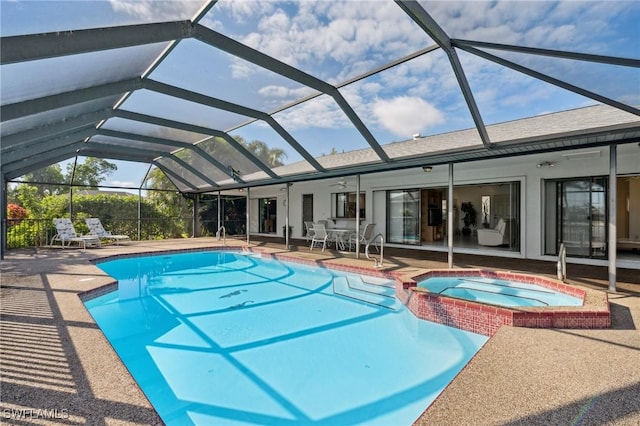 view of swimming pool featuring a patio area, an in ground hot tub, ceiling fan, and glass enclosure