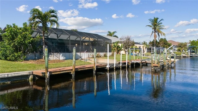 dock area with a water view, a lanai, and a lawn