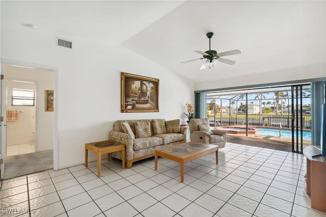 tiled living room with ceiling fan and vaulted ceiling