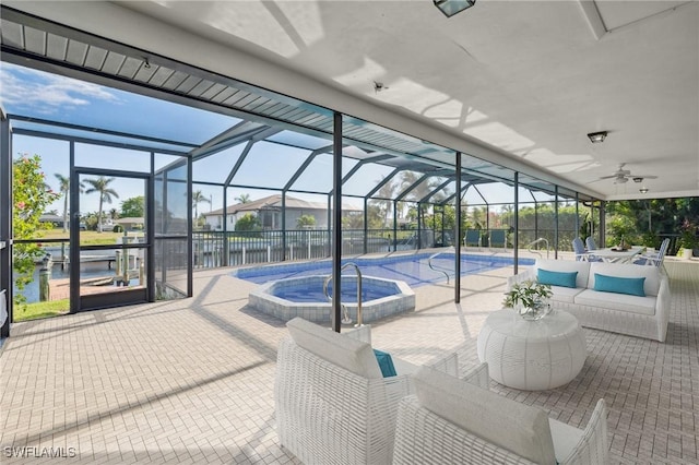 view of pool with an in ground hot tub, an outdoor living space, glass enclosure, and a patio area