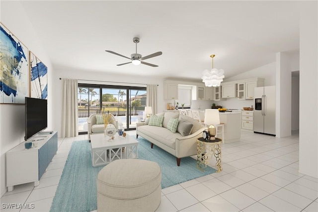 tiled living room featuring ceiling fan with notable chandelier and vaulted ceiling