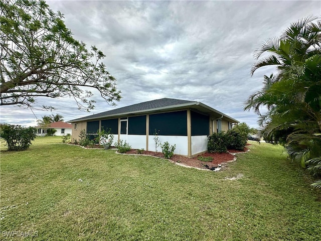 view of side of property with a lawn