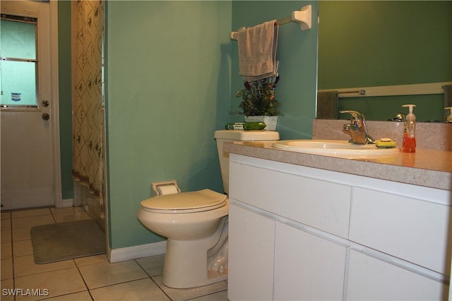 bathroom featuring toilet, vanity, and tile patterned floors