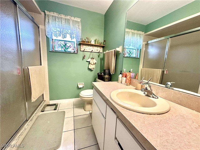 bathroom with toilet, vanity, tile patterned floors, and an enclosed shower