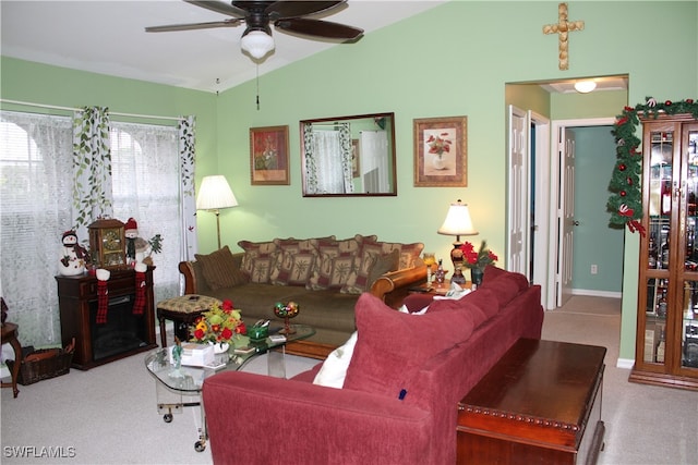 living room featuring light colored carpet, ceiling fan, and lofted ceiling