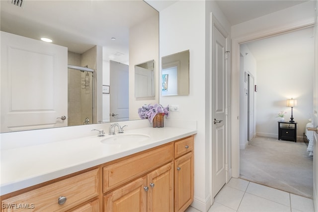 bathroom with tile patterned flooring, vanity, and a shower with shower door