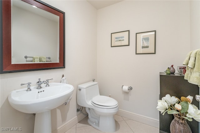 bathroom with tile patterned flooring and toilet