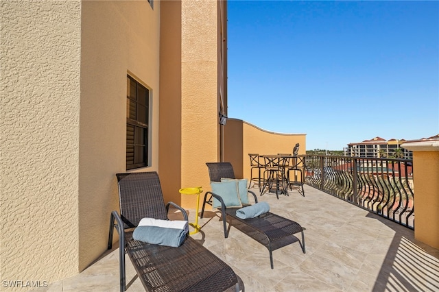 view of patio featuring a balcony