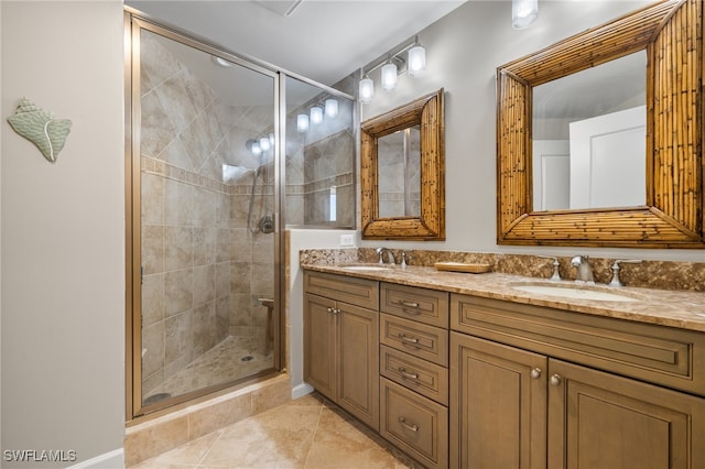 bathroom featuring a shower with door, vanity, and tile patterned flooring