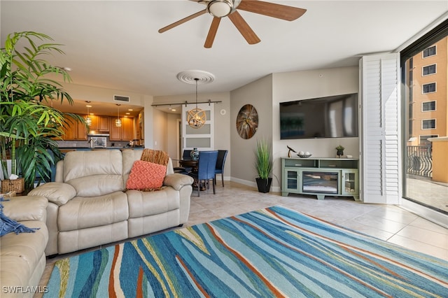 living room with ceiling fan and light tile patterned flooring